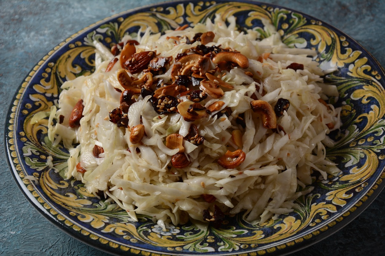 Cranberry and walnuts Coleslaw salad on a plate. Mediterranean salad. Israeli food